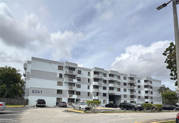 Front view of a multi-story residential building with balconies.