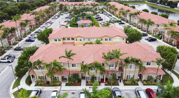 Elevated view of a residential complex with multiple two-story houses featuring red-tiled roofs.
