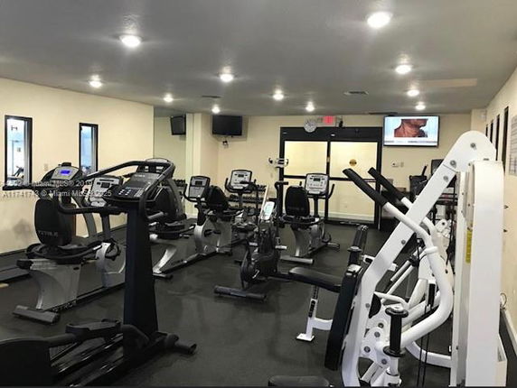 Indoor gym area with various exercise machines and equipment.