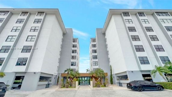 Front view of a modern multi-story building complex with two symmetrical structures.