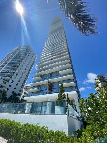 Front view of a high-rise building with multiple balconies.