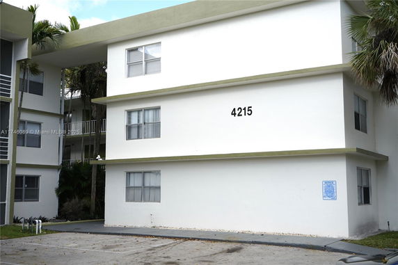 Front view of a multi-story building with the number 4215 on the facade.