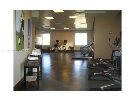Indoor recreation area with exercise equipment like treadmills and stationary bikes.