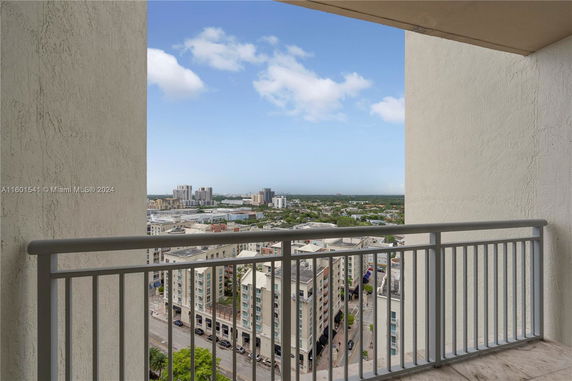 View from a high-rise building balcony overlooking a cityscape.