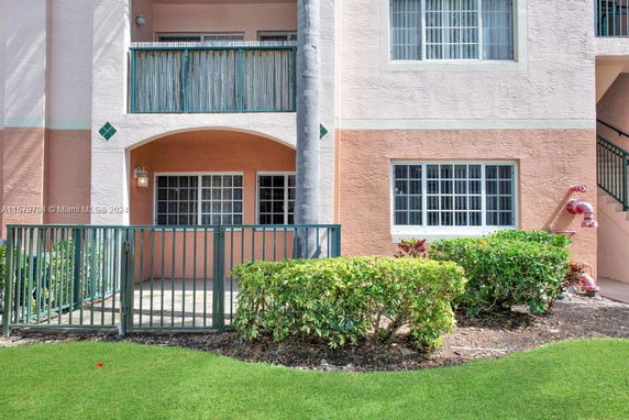 Front view of a multi-story building with balconies and windows.