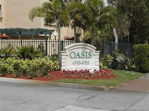 Front view of building entrance with sign labeled 'Oasis'.