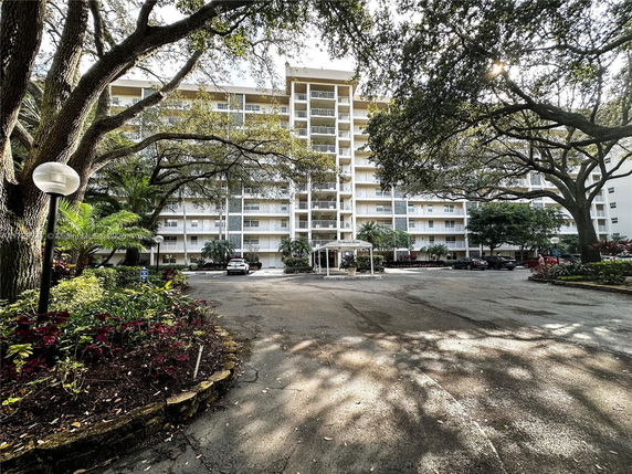 Front view of a multi-story apartment building with balconies.