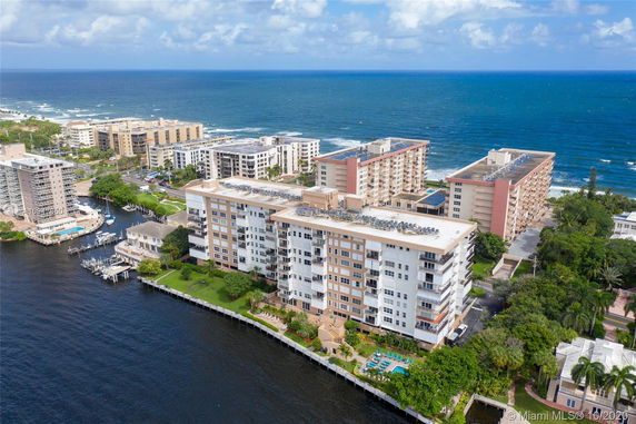 Aerial view of a coastal area with multi-story residential buildings by the water.