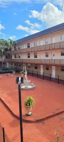 Front view of a multi-story building with multiple balconies.