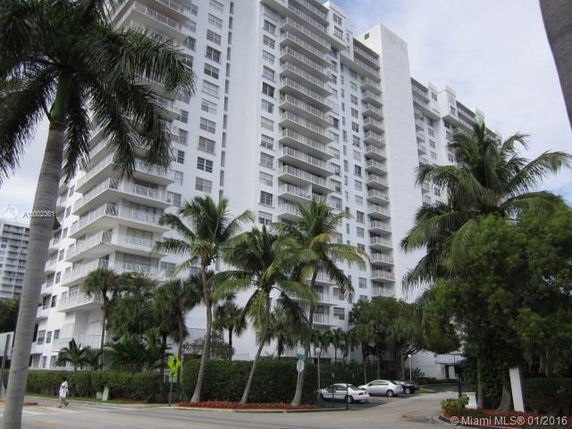 Front view of a high-rise residential building with multiple balconies.