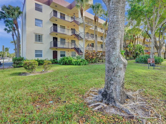 Front view of a multi-story apartment building with balconies.