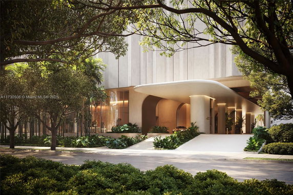 Front view of a modern building entrance with a sleek canopy and lush landscaping.