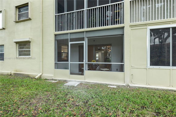 Front view of a building with screened windows and doors.
