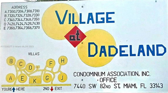 Sign for Village at Dadeland with addresses and site map.