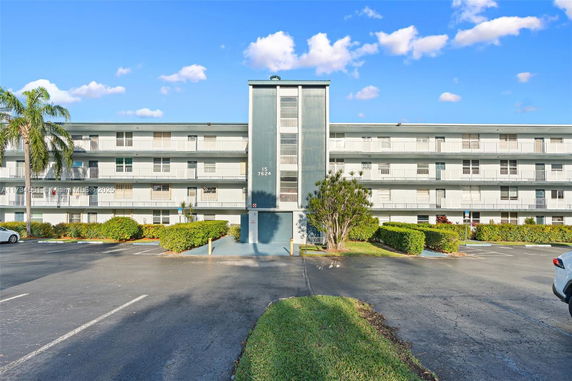 Front view of a multi-story residential building with balconies.