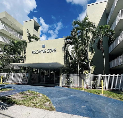 Front view of a multi-story building with a prominent entrance and balconies.