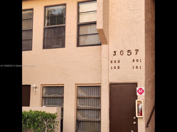 Front view of a building with several apartment numbers displayed.
