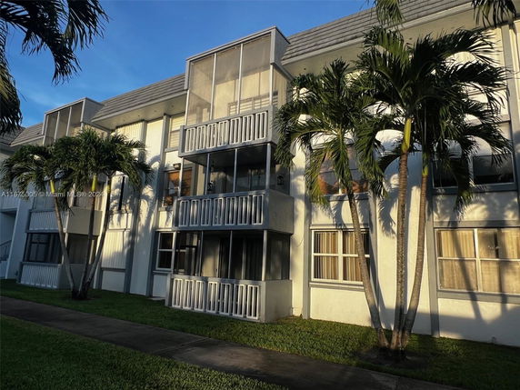 Front view of a multi-story residential building with balconies.