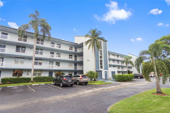 Front view of a multi-story residential building with balconies.