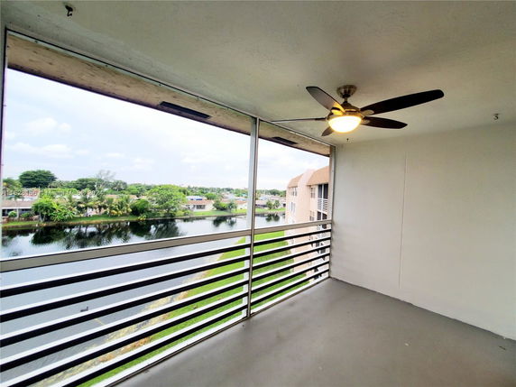 View from a balcony overlooking a water body and residential area.
