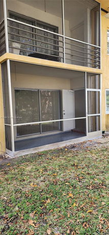 Front view of a building with screened balconies on two levels.