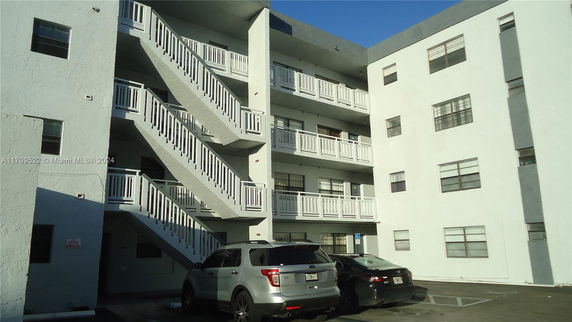 Front view of a multi-story building with exterior staircases.