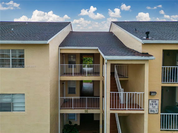 Front view of a multi-story residential building with exterior staircases.
