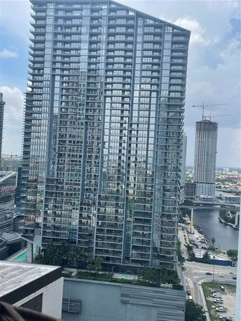 View of tall modern buildings with glass facades in a cityscape.