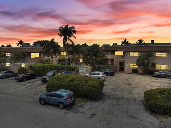 Front view of a two-story building with an outdoor parking area.