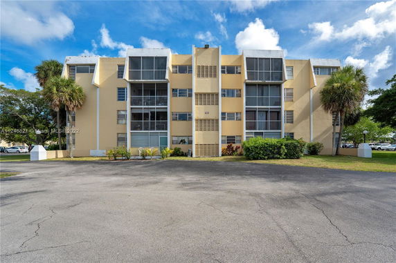 Front view of a multi-story apartment building with balconies.