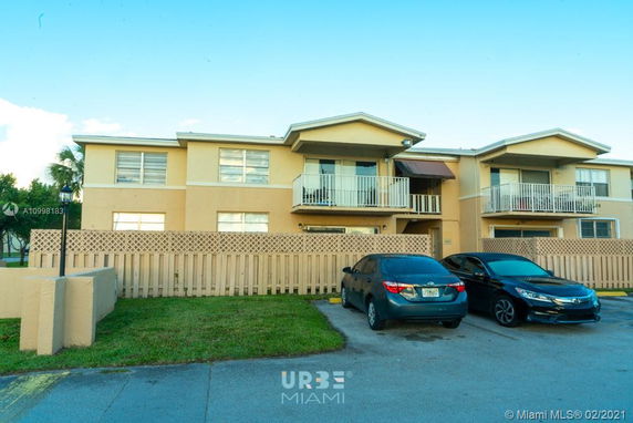 Front view of a two-story residential building with balconies.