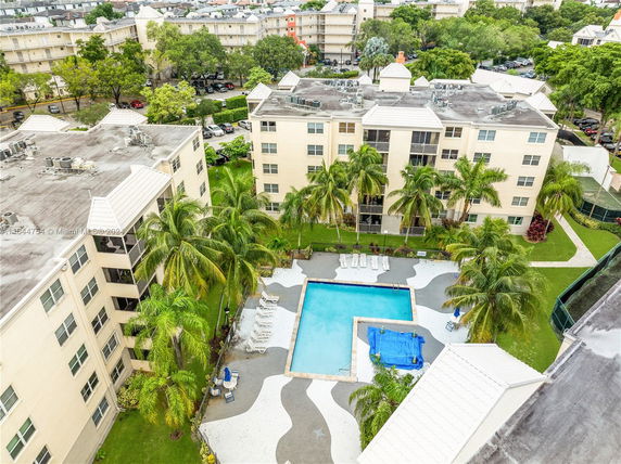 Aerial view of apartment buildings with a swimming pool area.