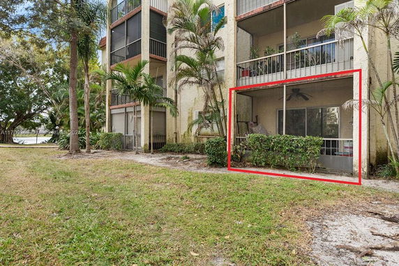 View of a multi-story apartment building with balconies and greenery.