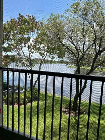 View of trees and a body of water from a balcony.