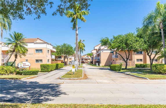 Front view of a low-rise residential complex with multiple units.