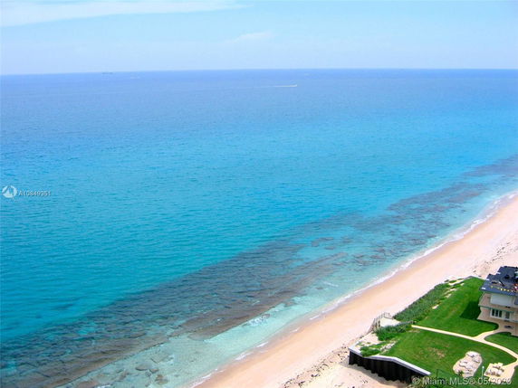 Panoramic view of a beach and ocean from a high vantage point.