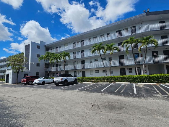 Front view of a multi-story residential building with balconies.