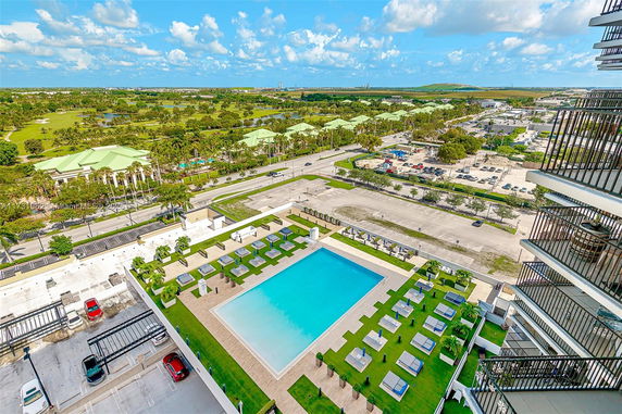 Rooftop view highlighting a swimming pool and outdoor seating area.