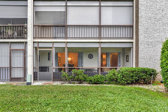 Front view of a multi-story building with screened balconies.