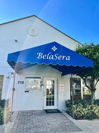 Front view of a building entrance with an awning labeled 'BelaSera'.