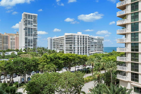 View of multiple high-rise buildings with ocean in the background.