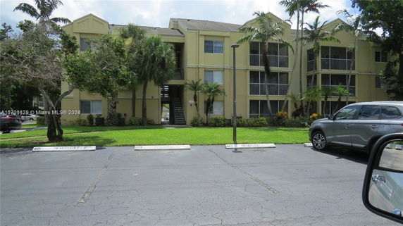 Front view of a multi-story residential building with balconies.