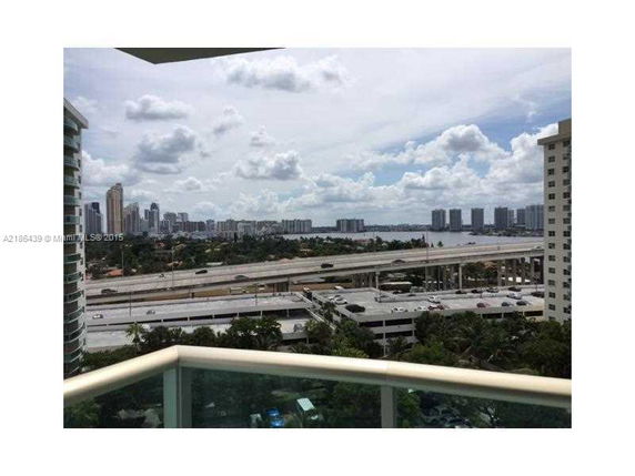 View from a building showing a cityscape with roads and high-rise buildings in the distance.