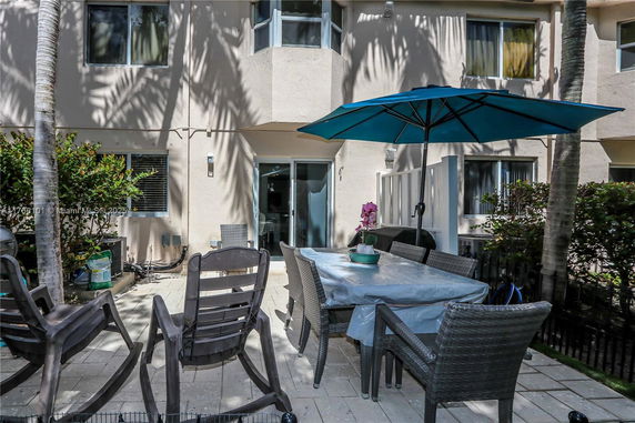 Front view of a multi-story building with outdoor seating area.
