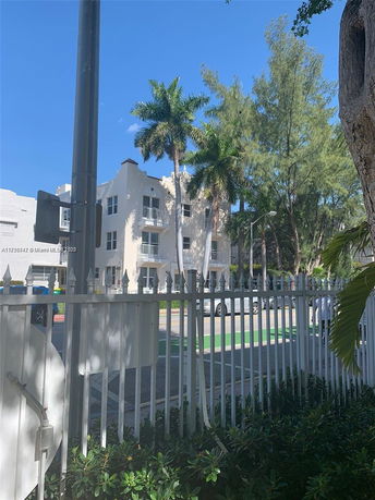 Front view of a multi-story residential building with balconies.