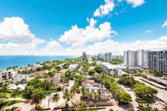 Panoramic view of coastal cityscape with buildings and ocean.