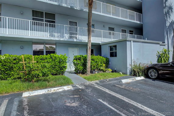 Front view of a multi-story building with balconies.