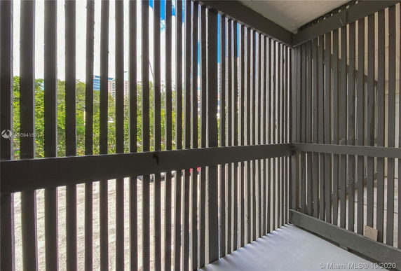 View through wooden slats of a building and trees