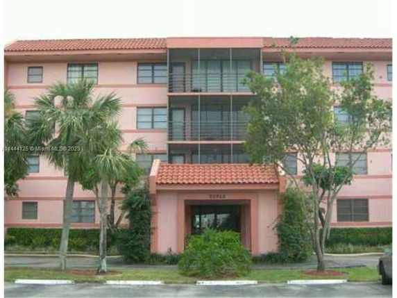 Front view of a multi-story residential building with balconies.
