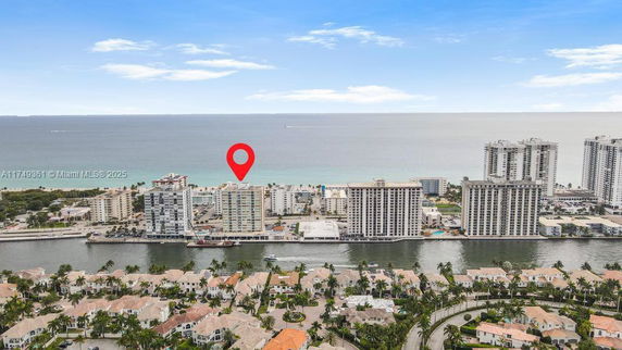 Aerial view of seaside buildings with a beach in the background.